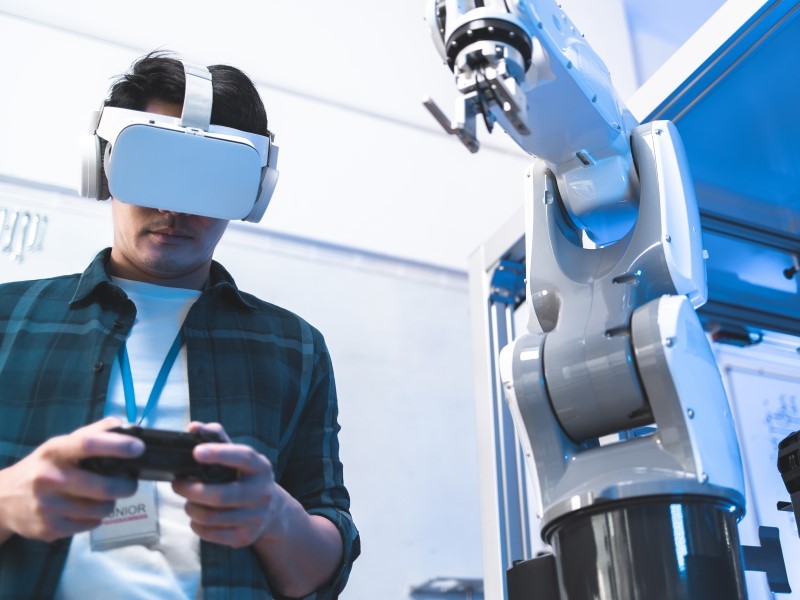 Worker uses Augmented Reality goggles to perform a task.
