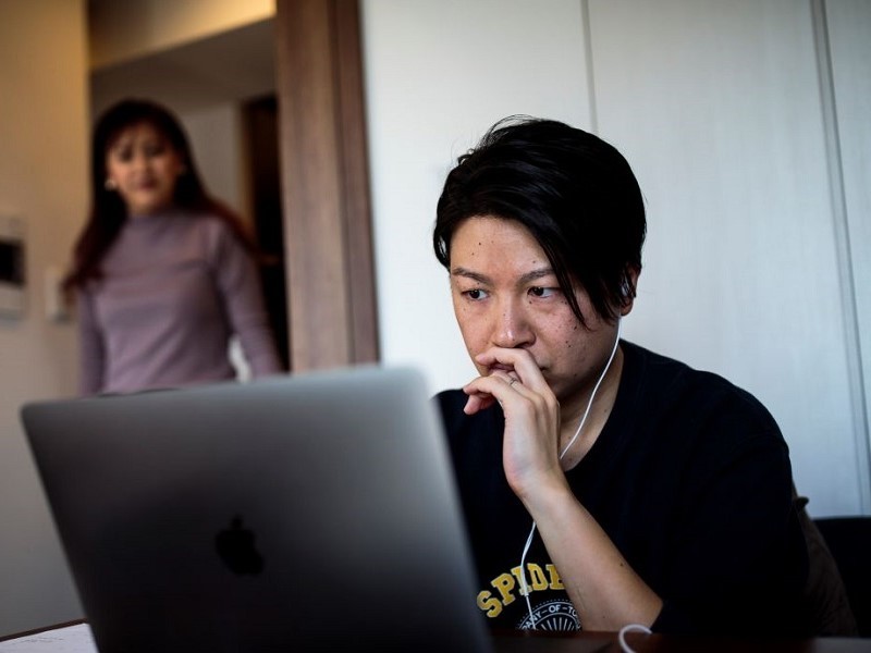 Tech-savvy employee working in his home