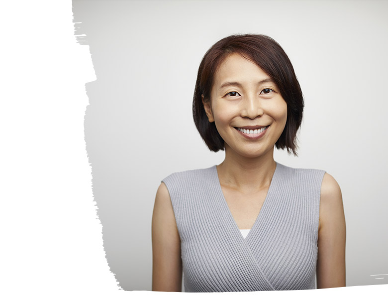 Portrait of a smiling businesswoman taking a picture in an office space