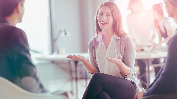 Positive smiling female investor mid conversation