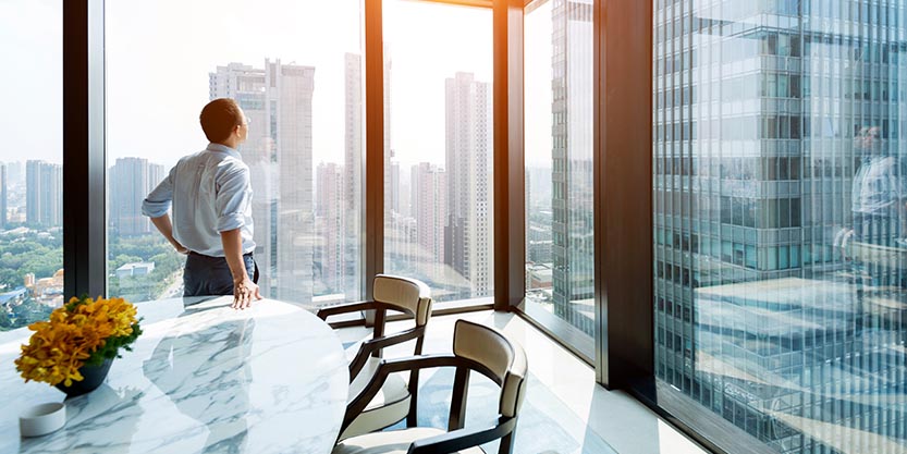 Man looking outside from office window 