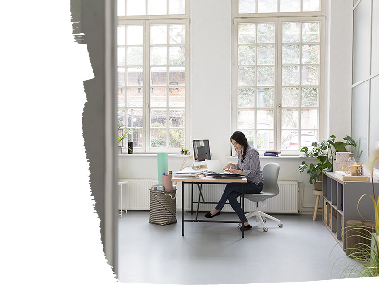Woman working at desk in a loft office