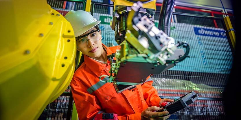 Woman mechanic worker in motion of attending of work on paddle robot controller