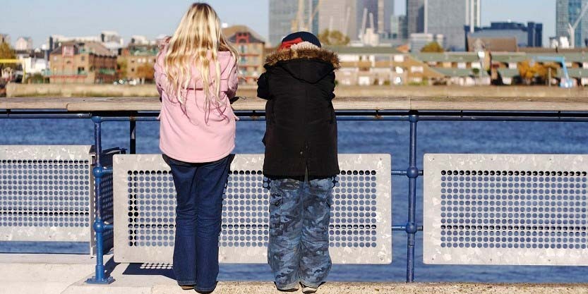 Two investors dicussing standing at the river bank