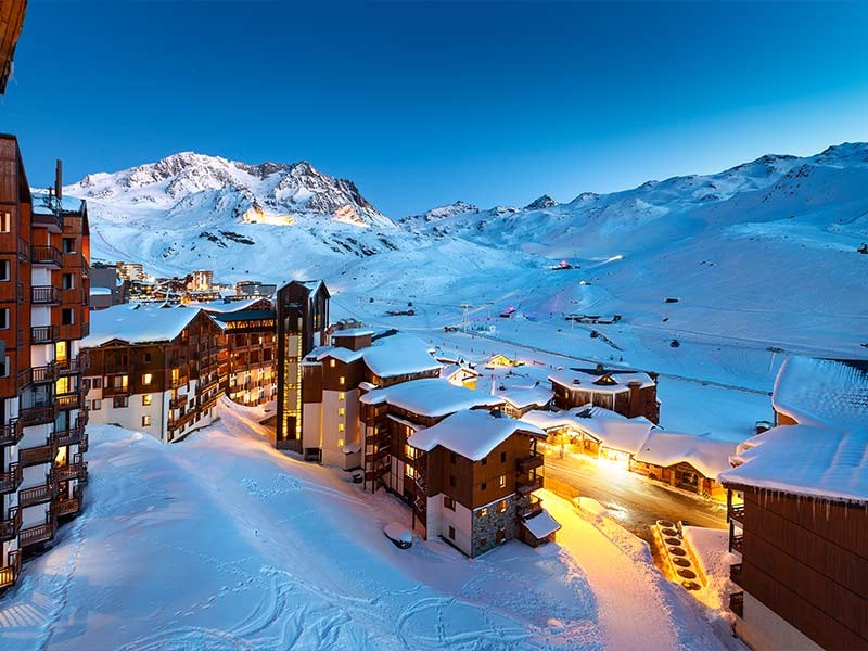 Panorama of snowy mountains and hotels in a French Alps ski resort