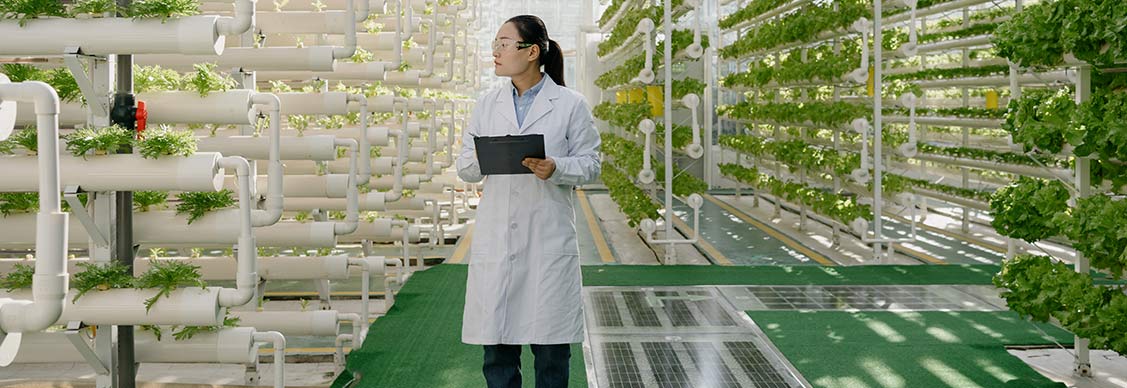 Women is standing and holding IPAD in her hand