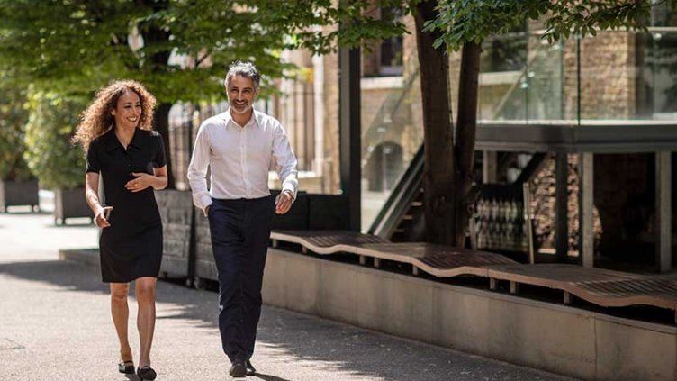 A man and woman walking and smiling