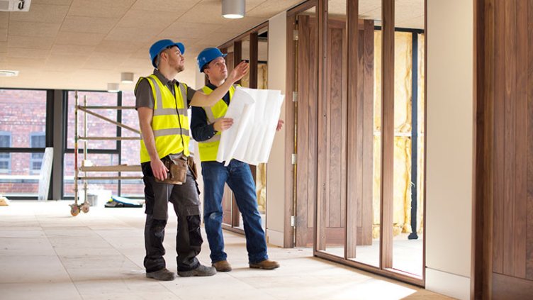 Two architects discussing the model of new real estate project