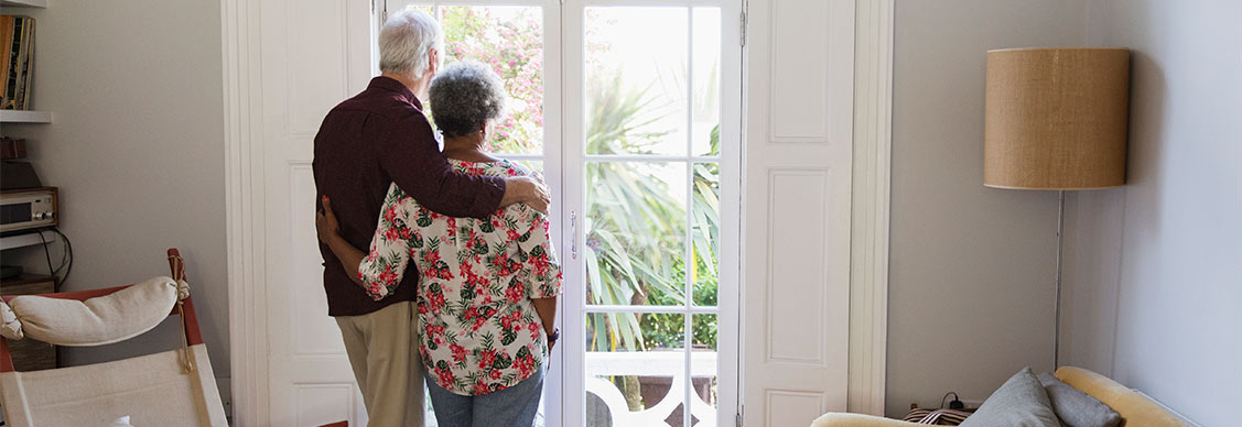 Two people looking outside the door