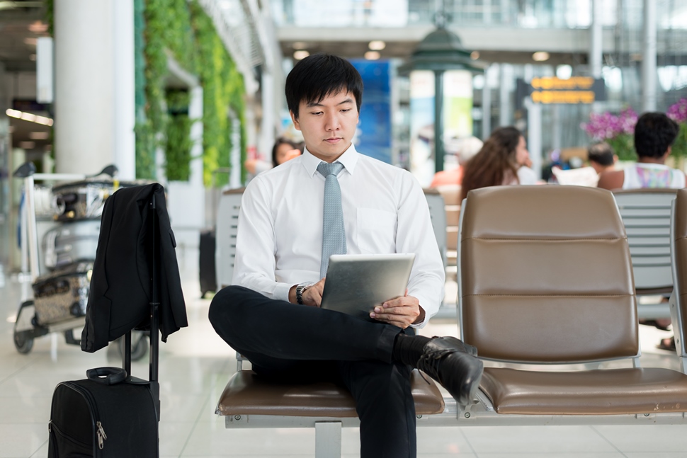 Asian businessman using digital tablet while waiting in lounge at airport.Business travel concept.; Shutterstock ID 475645810; Departmental Cost Code : 162800; Project Code: GMKT_SUP_4.9.1E; PO Number: GBLMKT/2015-082