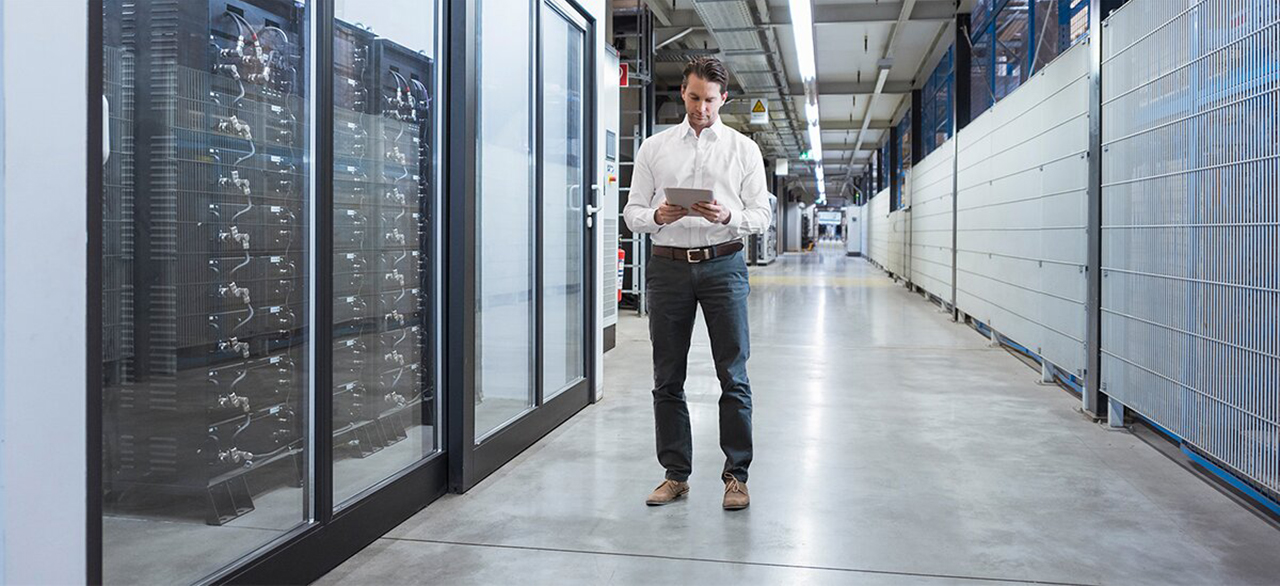 businessman using tablet in modern factory